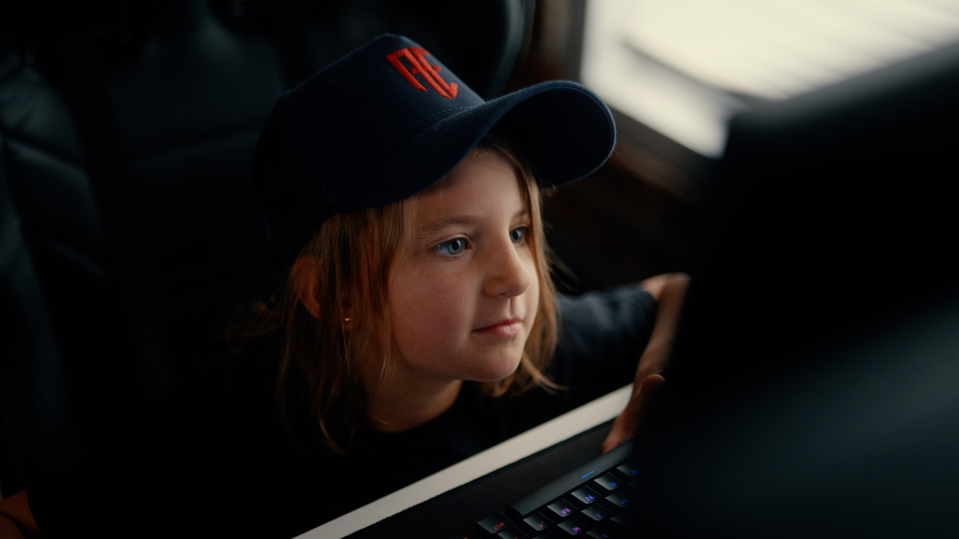 A young player in an Affinity Esports cap at a station